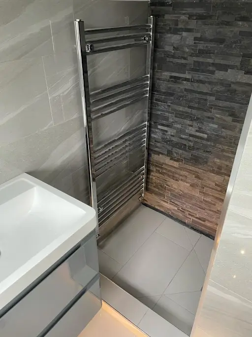Stone feature wall tiling in a wet room, Bexley